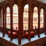 Curved arches and intricate jaalis along the corridors at Narendra Bhawan